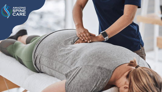 Chiropractor working on female patients back