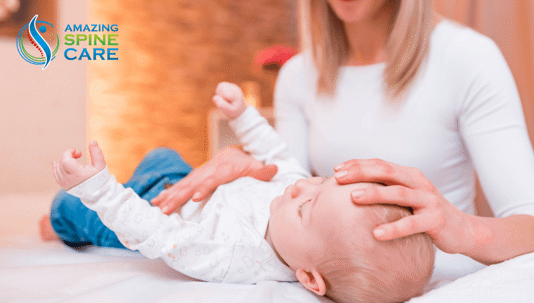 Chiropractor treating baby