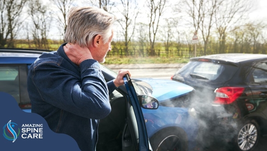 holding neck after suffering whiplash in accident